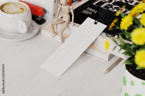 Paper bookmark at workplace mockup. 3D rendering
