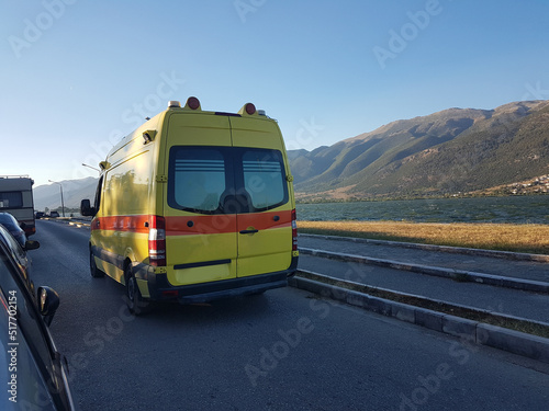ambulance in the evening moving by the lake