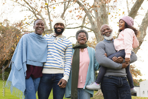 Image of happy multi generation african american family posing at camera outdoors in autumn