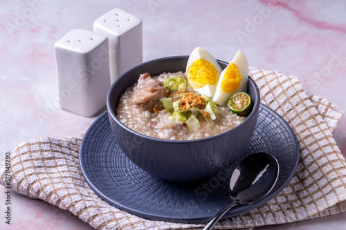Arroz caldo, is a Filipino rice and chicken gruel heavily infused with ginger and garnished with toasted garlic, scallions, and black pepper. It is usually served with calamansi or fish sauce (patis) 