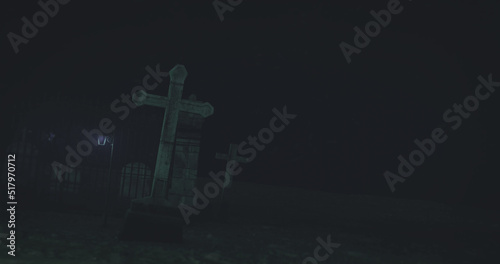 Image of graves on cemetery at night
