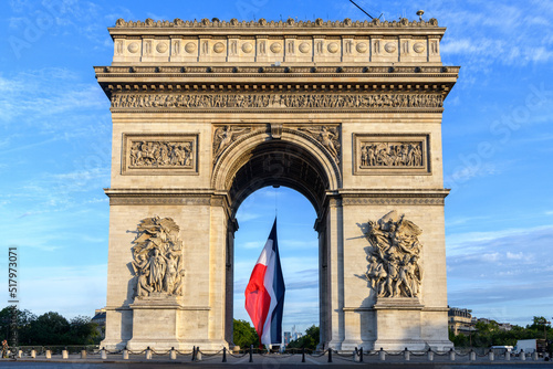 FRANCE - PARIS - CHAMPS ELYSEES - JULY 14 2022. Early in the morning, the French flag is raised under the Arc de Triomphe for the Bastille Day.