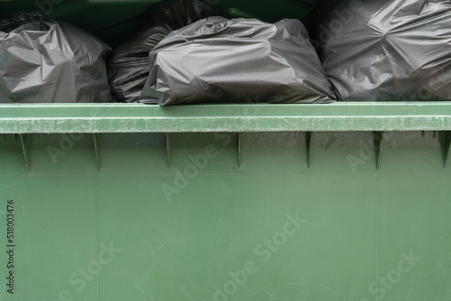 green bin full of garbage bag background