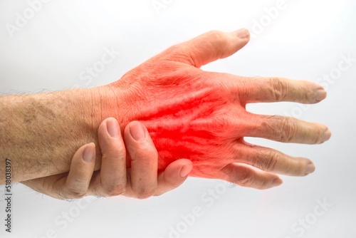 Pain in hand of Asian man. Concept of hand pain, tendinitis and joint problems.