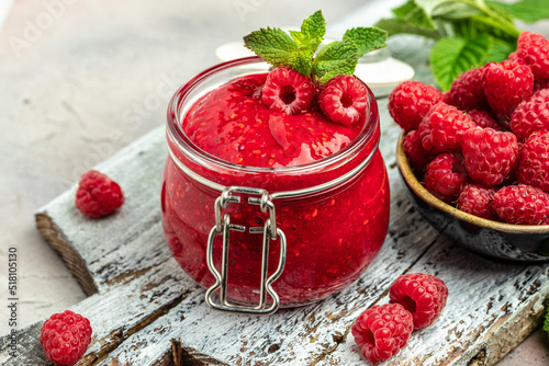 Raspberry jam with berry on light background. Homemade jam with raspberry. banner, menu, recipe place for text, top view