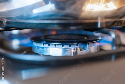 Combustion of household gas on a gas stove, gas energy saving concept.Closeup.