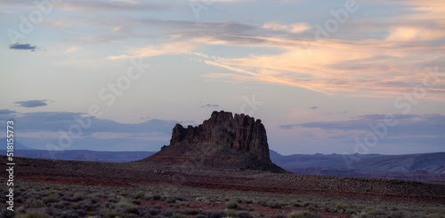 Red Rock Mountain Landscape during colorful sunset sky. Alhambra Rock near Mexican Hat, Utah, United States. American Nature Background