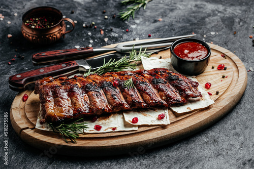 Spicy rack of spare ribs with BBQ sauce served on wood chopping board, Restaurant menu, dieting, cookbook recipe top view