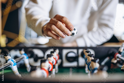 Man playing football match on table soccer