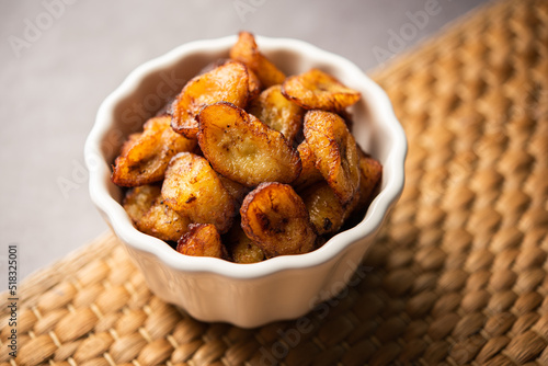 Deep fried ripe plantain slices or pake kele fried chips in a bowl