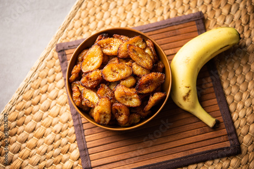 Deep fried ripe plantain slices or pake kele fried chips in a bowl