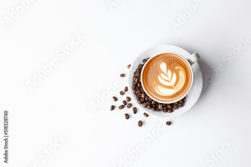 cup of coffee and bean on white table background. top view