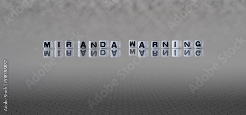 miranda warning word or concept represented by black and white letter cubes on a grey horizon background stretching to infinity