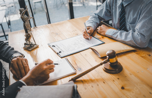 Close-up of a judge with a hammer against the background of professional lawyer talking about a lawsuit. professional lawyers discussing legal case.