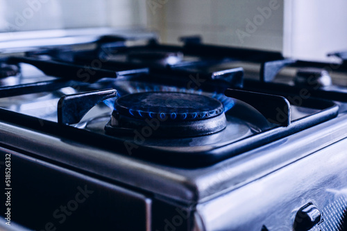 Kitchen gas hob, stove cook with blue flames burning
