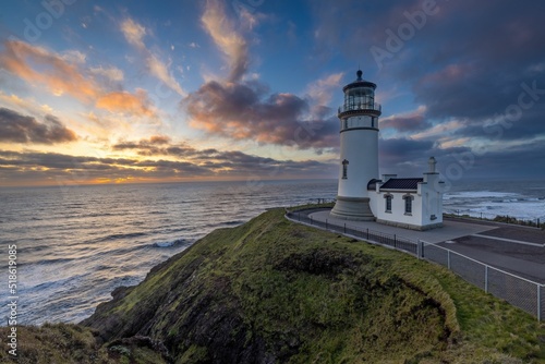 Beautiful shot of the North Head Lighthouse on a hill at sunset in Ilwaco, Washington