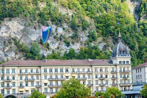 Old hotel building and paraglider in Interlaken, Switzerland