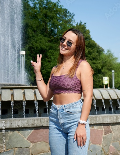 Beautiful Hispanic girl in purple top posing for picture in front of Atomium in Brussels