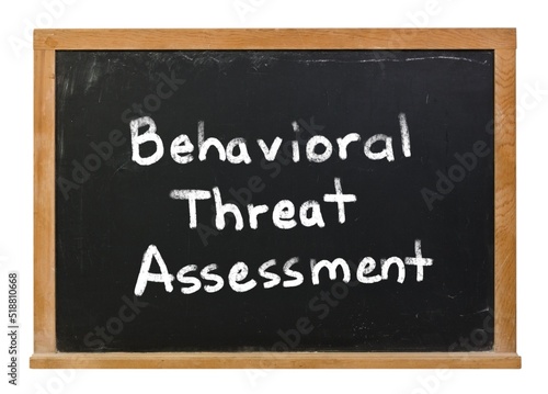 Behavioral threat assessment written in white chalk on a black chalkboard isolated on white