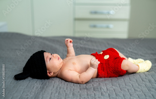 First birthday. Adorable cute baby lying in mickey mouse costume.