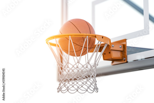 Basketball ball in tha basketball hoop on a street basketball court.