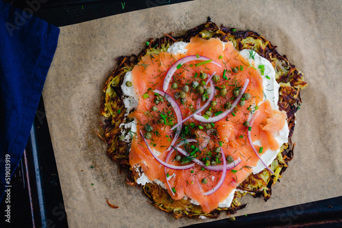 Potato Pancake Topped with Smoked Salmon and Labneh: Latkes topped with nova, capers, red onions, and fresh herbs