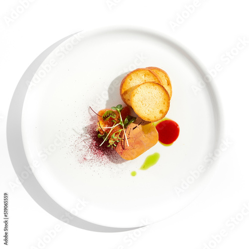 Chicken liver pate with toasted bread and jam isolated on white background. Meat terrine with citrus and toast. Restaurant food - duck pate with baguette on white plate. Meat appetizer.