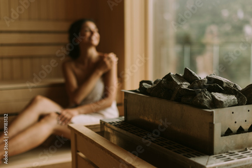 Young woman relaxing in the sauna