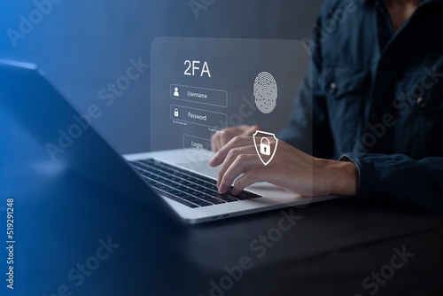 Person using laptop and touching virtual screen for two-factor authentication for safety use of social networks and access to information privacy