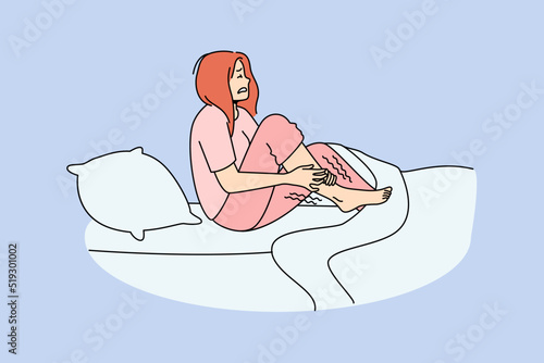 Unhappy woman in bed at night suffer from restless leg syndrome. Unhealthy female struggle with cramp. Healthcare concept. Vector illustration. 