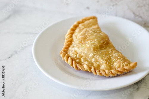 Cornish pasty filled with chicken and potato. Pastry minced pie or Pastel asian style cuisine. Homemade flaky pasty with mince meat filling
