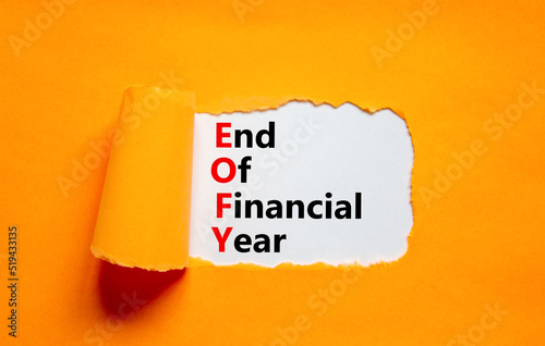 EOFY end of financial year symbol. Concept words EOFY end of financial year on white paper on beautiful orange background. Black calculator and pen. Business and EOFY end of financial year concept.