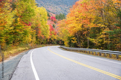 Mountain pass road through a colourful forest in autumn. Kancamagus highway, NH, USA.
