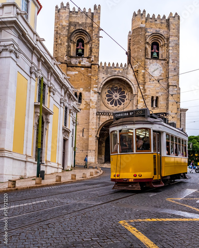 Yellow tram no. 28 at the Cathedral of Sé in Lisbon. Portugal