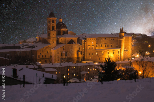 Beautiful starry sky over Urbino old city in the marche region with snow