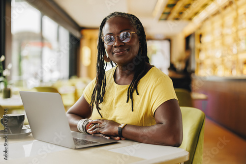 Confident business owner working her a cafe