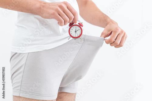 Erection and potency. alarm clock in hand of man at trunks underwear. Time. Mens health. Sexual vigor.