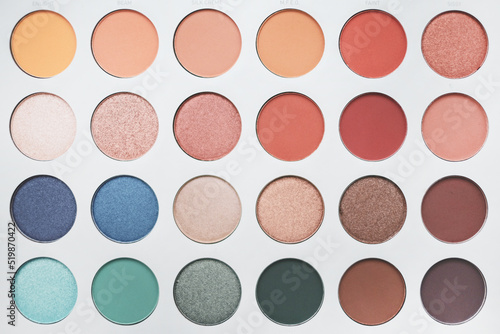 Selective focus of eyeshadow palette with various colors in pearly and matte closeup