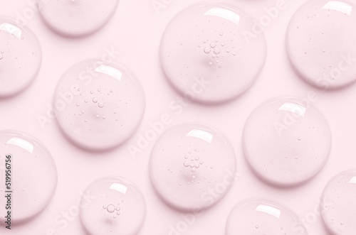 Pink drops of gel closeup. Cosmetic product for moisturizing the skin of the face or body.