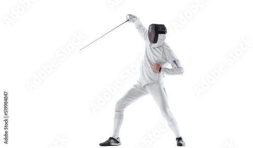 Dynamic portrait of young man, fencer in in fencing costume with sword in hand training isolated on white studio background. Sport, energy, skills