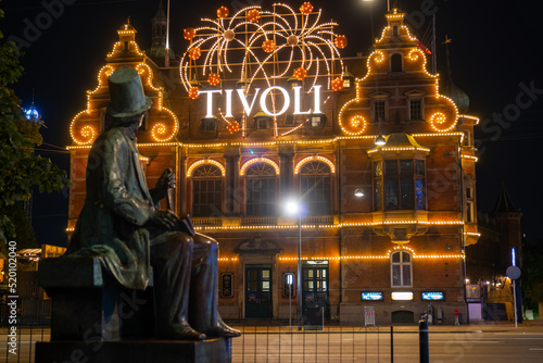 Hans Christian Andersen statue and Tivoli building facade, built in 1843. Entrance to Tivoli Garden, one of the oldest operating amusement parks in the world. Copenhagen - Denmark