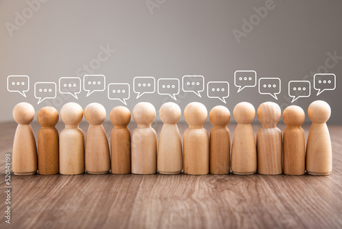 Wooden figurine with speech bubble. Mingle, discussion, chatting concept