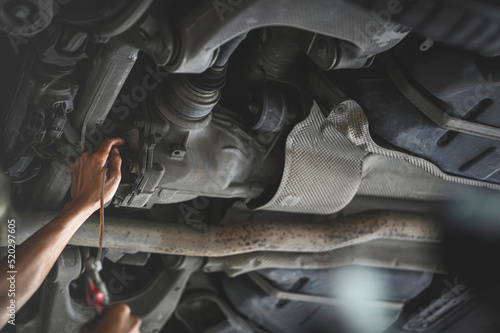 Auto mechanic filling rear differential fluid ,rear differential fluid service.