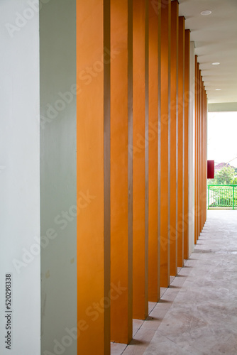 The cream color wall pillar in the hallway of the building
