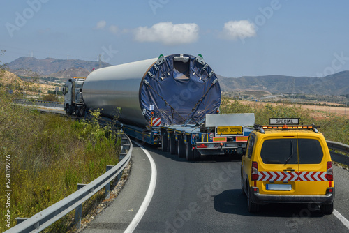 Special transport of large dimensions taking a curve with caution, transport of a piece of a wind turbine.
