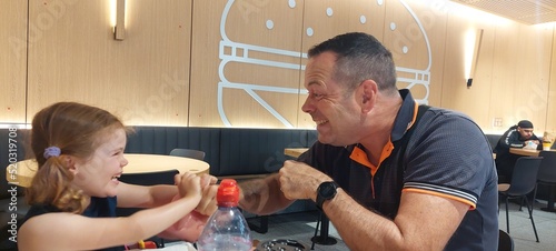 Dad and daughter at McDonalds restaurant earing and having fun