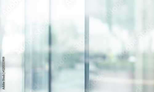 Blurred images of glass wall with city town background.modern abstract window