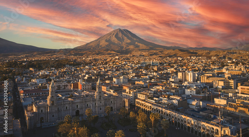 Aerial drone view of Arequipa main square and cathedral church, with the Misti volcano at sunset. Arequipa, Peru.