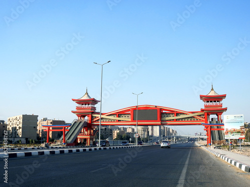 Shinzo Abe axis patrol highway in Egypt with a pedestrian bridge finished in traditional Japanese architectural style, the traffic highway is named on former Japanese PM