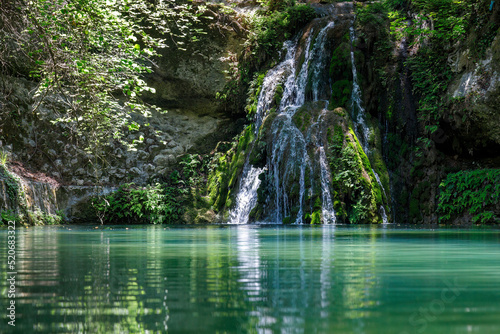 Waterfall in The Valley of Butterflies. The Petaloudes valley nature reserve in Rhodes, Greece, Europe.